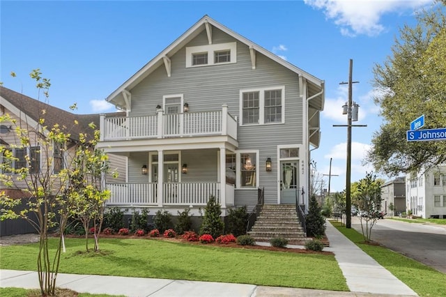 444244 S Johnson St, New Orleans, LA 70125 - view of front of property with covered porch, a balcony, and a front lawn