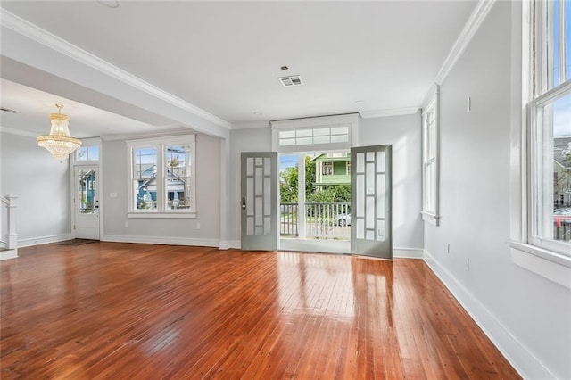 444244 S Johnson St, New Orleans, LA 70125 - unfurnished room featuring wood-type flooring, a healthy amount of sunlight, a chandelier, and visible vents