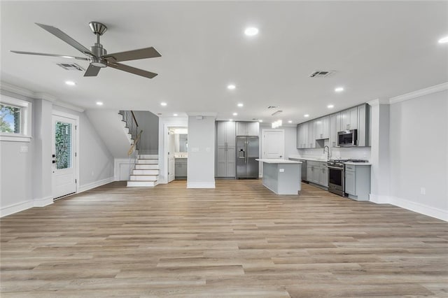 444244 S Johnson St, New Orleans, LA 70125 - kitchen with gray cabinetry, visible vents, stainless steel appliances, and open floor plan