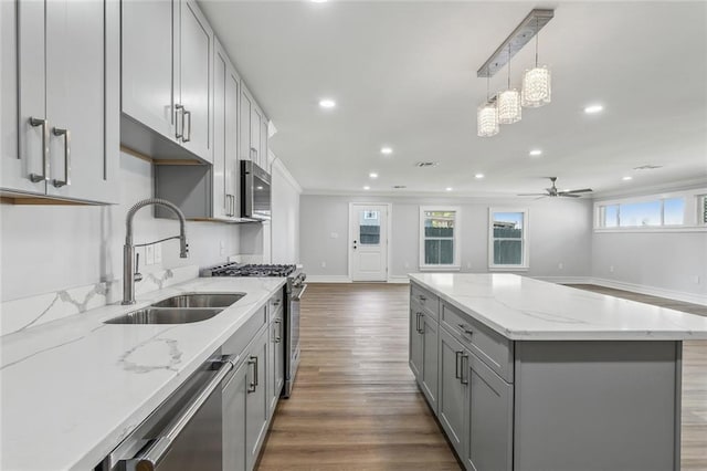 444244 S Johnson St, New Orleans, LA 70125 - kitchen with a sink, appliances with stainless steel finishes, a center island, gray cabinetry, and open floor plan