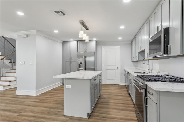 444244 S Johnson St, New Orleans, LA 70125 - kitchen featuring high quality appliances, a sink, gray cabinetry, visible vents, and ornamental molding