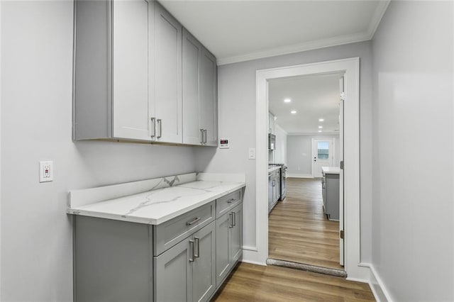 444244 S Johnson St, New Orleans, LA 70125 - laundry area with baseboards, crown molding, wood finished floors, and recessed lighting