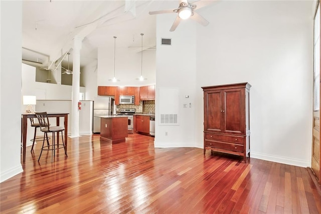 920 Poeyfarre St Unit 170, New Orleans, LA 70130 - unfurnished living room featuring high vaulted ceiling, dark wood-style flooring, ceiling fan, and baseboards