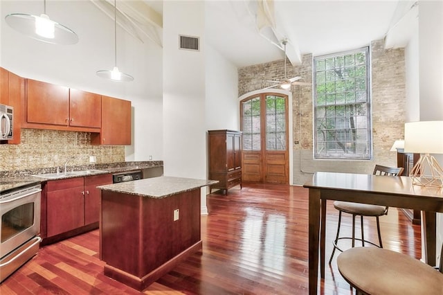 920 Poeyfarre St Unit 170, New Orleans, LA 70130 - kitchen featuring stainless steel range with electric cooktop, dark wood finished floors, healthy amount of natural light, a towering ceiling, and beamed ceiling