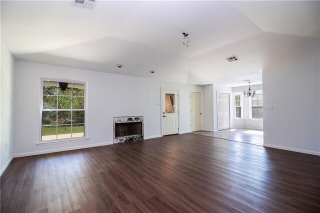 132 Belle Grove Dr, La Place, LA 70068 - living area with a notable chandelier, visible vents, wood finished floors, and vaulted ceiling