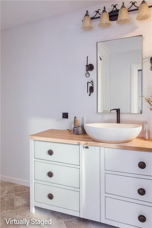 bathroom featuring baseboards and vanity