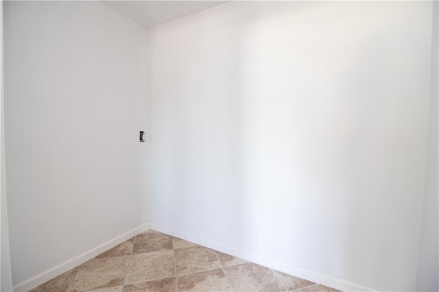unfurnished room featuring baseboards