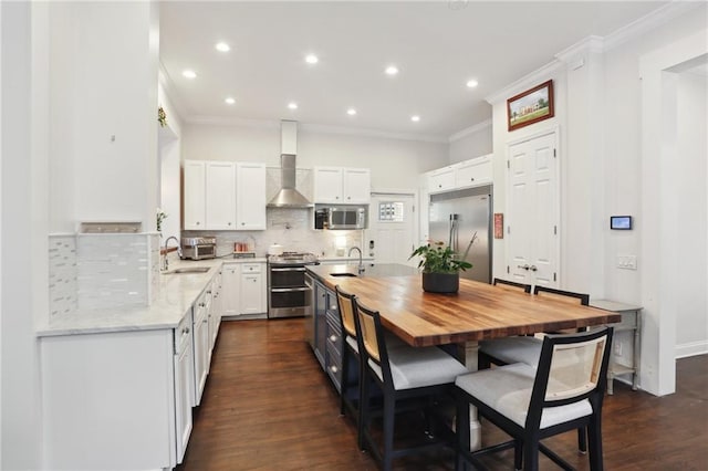 740 Florida Blvd, New Orleans, LA 70124 - kitchen with stainless steel appliances, wall chimney exhaust hood, wood counters, a sink, and crown molding