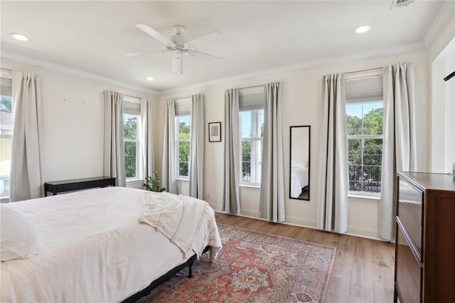 740 Florida Blvd, New Orleans, LA 70124 - bedroom featuring multiple windows, wood finished floors, ornamental molding, and recessed lighting