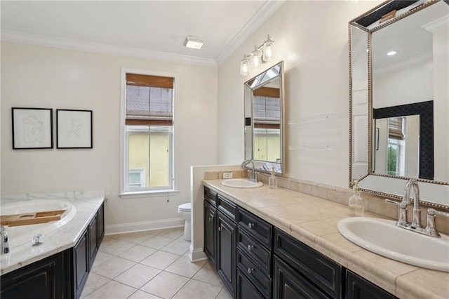 740 Florida Blvd, New Orleans, LA 70124 - full bathroom featuring double vanity, toilet, crown molding, tile patterned flooring, and baseboards
