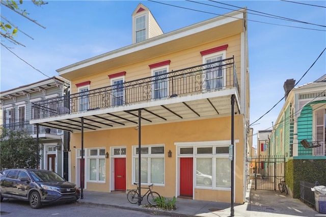 back of house featuring a balcony