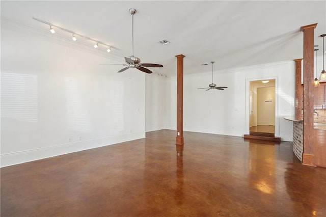 unfurnished living room with ceiling fan, concrete floors, crown molding, baseboards, and track lighting