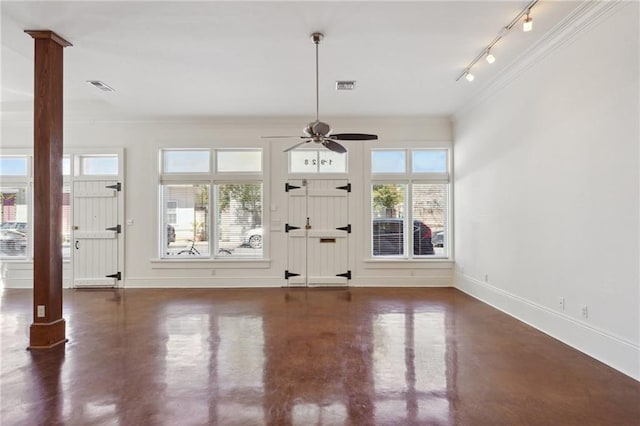foyer featuring a ceiling fan, rail lighting, concrete floors, healthy amount of natural light, and crown molding
