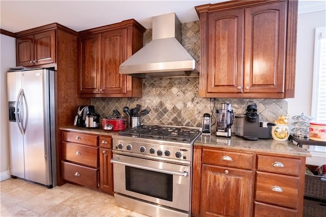 4012 Berot St, Metairie, LA 70002 - kitchen featuring stainless steel appliances, custom range hood, tasteful backsplash, light stone counters, and brown cabinets