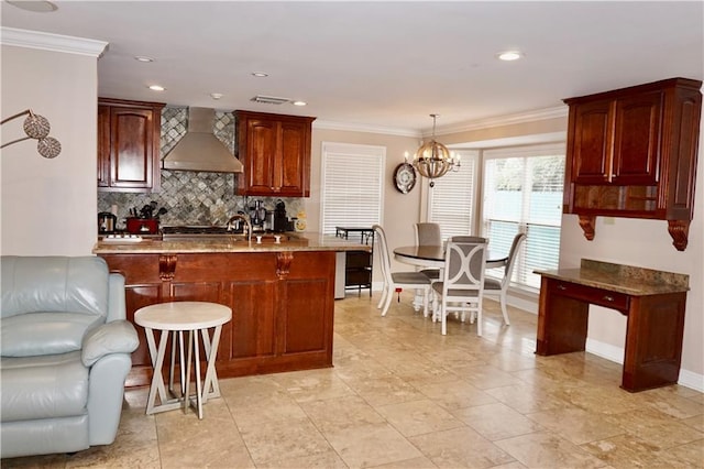 4012 Berot St, Metairie, LA 70002 - kitchen featuring wall chimney range hood, a chandelier, tasteful backsplash, baseboards, and crown molding
