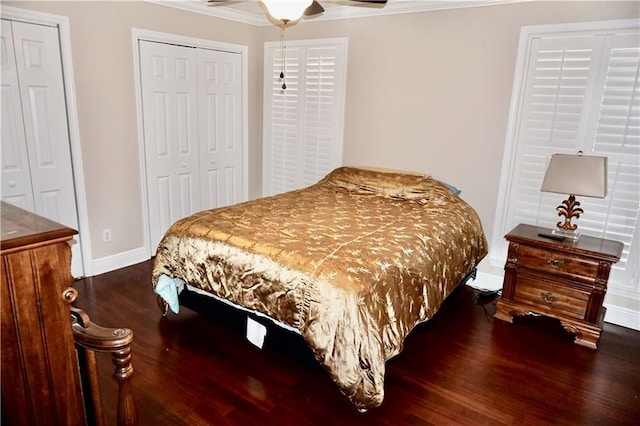4012 Berot St, Metairie, LA 70002 - bedroom with wood finished floors, ornamental molding, baseboards, multiple closets, and ceiling fan