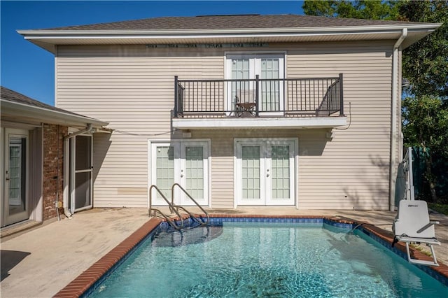 4012 Berot St, Metairie, LA 70002 - rear view of property featuring french doors, a balcony, an outdoor pool, and a patio