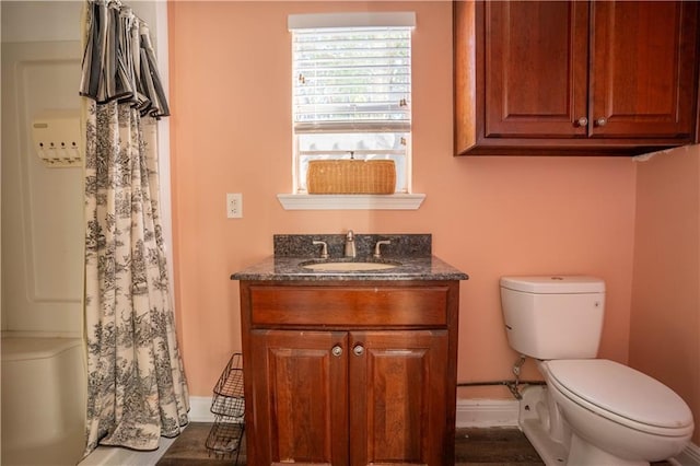 4012 Berot St, Metairie, LA 70002 - full bath with toilet, vanity, a shower with shower curtain, and wood finished floors