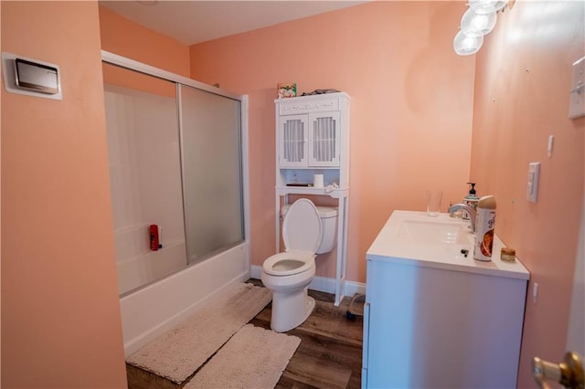 4012 Berot St, Metairie, LA 70002 - bathroom with toilet, wood finished floors, bath / shower combo with glass door, and vanity