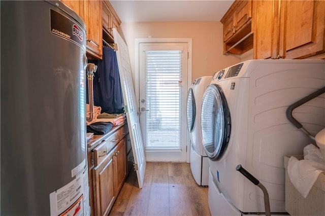 4012 Berot St, Metairie, LA 70002 - laundry area with independent washer and dryer, cabinet space, and light wood-type flooring