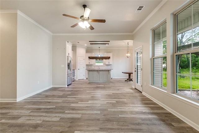 31527 Meadow Lark Ln, Denham Springs, LA 70726 - unfurnished living room with baseboards, visible vents, ceiling fan, and light wood-style floors