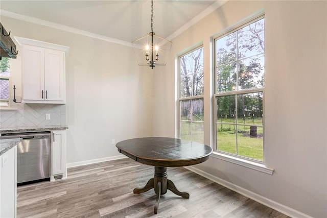 31527 Meadow Lark Ln, Denham Springs, LA 70726 - dining space featuring baseboards, a notable chandelier, crown molding, and light wood finished floors