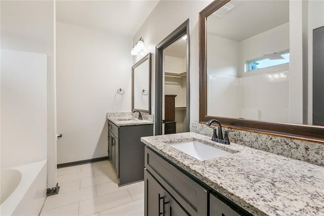 31527 Meadow Lark Ln, Denham Springs, LA 70726 - bathroom featuring tile patterned floors, two vanities, a bathing tub, and a sink