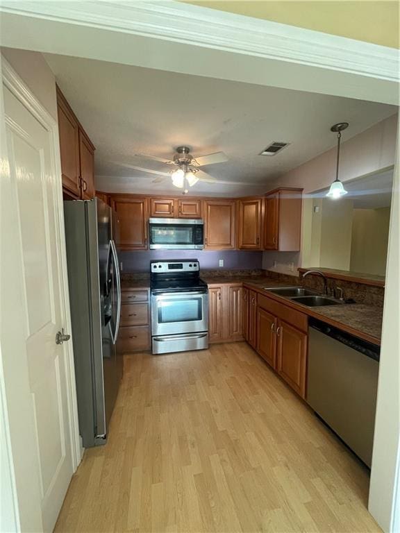 416 Marina Dr, Slidell, LA 70458 - kitchen featuring a sink, dark countertops, light wood-type flooring, and appliances with stainless steel finishes