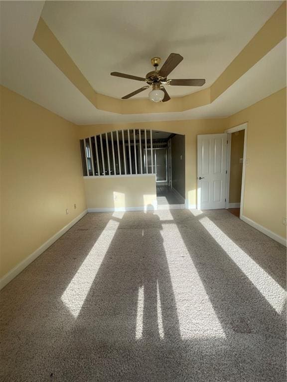 416 Marina Dr, Slidell, LA 70458 - carpeted empty room featuring baseboards, ceiling fan, and a raised ceiling