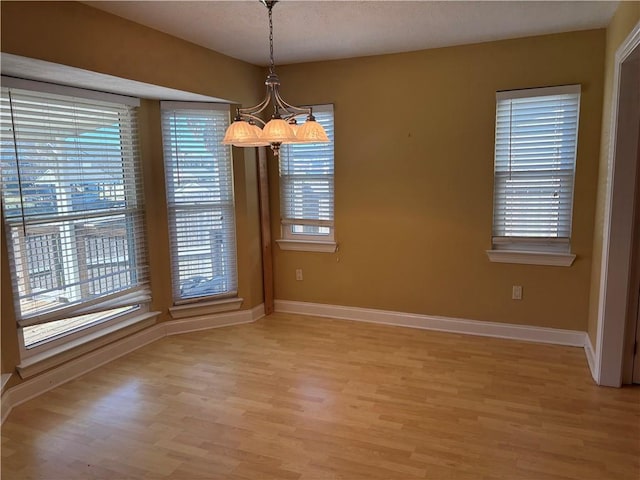 416 Marina Dr, Slidell, LA 70458 - unfurnished dining area with baseboards, an inviting chandelier, and plenty of natural light