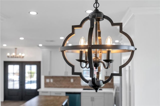 8820 Cohn St, New Orleans, LA 70118 - details featuring white cabinetry, light countertops, french doors, and a chandelier