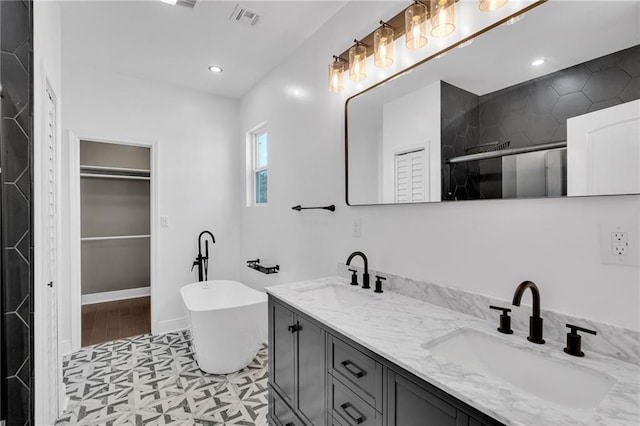 8820 Cohn St, New Orleans, LA 70118 - bathroom featuring a freestanding tub, a shower with door, visible vents, and a sink