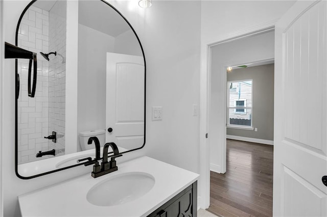 8820 Cohn St, New Orleans, LA 70118 - bathroom with baseboards, wood finished floors, a shower, and vanity