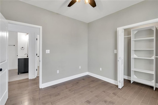8820 Cohn St, New Orleans, LA 70118 - unfurnished bedroom with baseboards, wood finished floors, and a ceiling fan