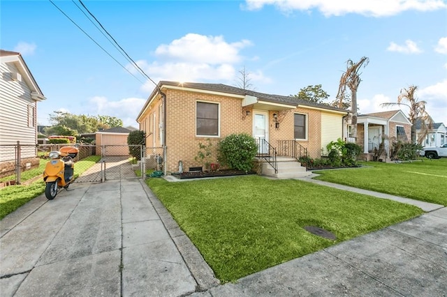view of front of house featuring a front yard, a gate, concrete driveway, fence, and brick siding