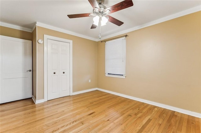 unfurnished bedroom with baseboards, ornamental molding, light wood-style floors, and ceiling fan