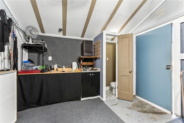 interior space featuring baseboards, lofted ceiling, concrete floors, and a textured ceiling