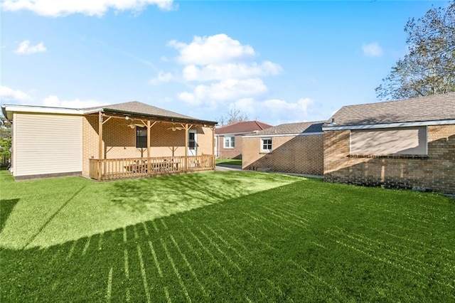 rear view of property featuring a patio area, brick siding, and a yard