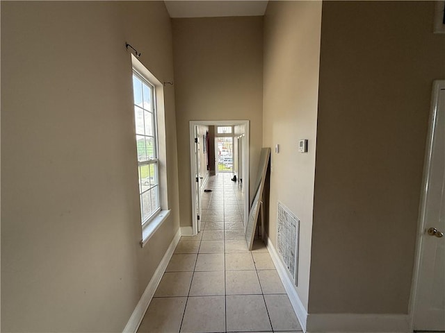 1827 S Rampart St, New Orleans, LA 70113 - corridor with healthy amount of natural light, light tile patterned floors, baseboards, and a high ceiling