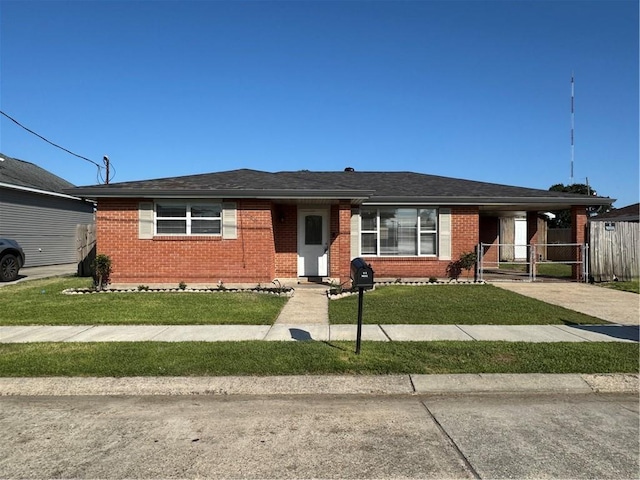 3020 Decomine Dr, Chalmette, LA 70043 - view of front of house featuring brick siding, a front lawn, and driveway