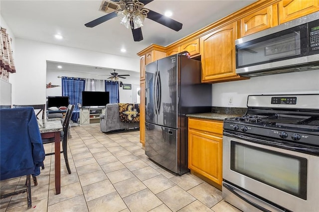 3020 Decomine Dr, Chalmette, LA 70043 - kitchen with stainless steel appliances, a ceiling fan, dark countertops, open floor plan, and recessed lighting
