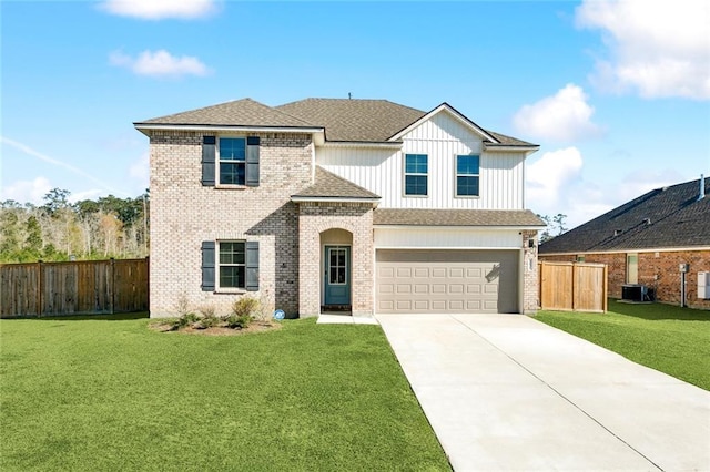 traditional-style house featuring brick siding, a front yard, fence, and driveway