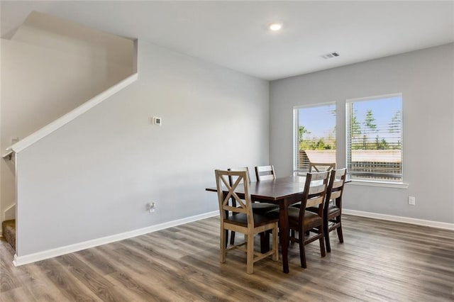 dining room featuring wood finished floors, baseboards, visible vents, and recessed lighting