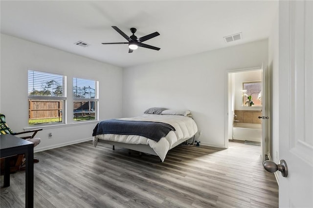 bedroom with ceiling fan, visible vents, baseboards, and wood finished floors