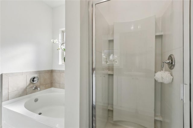 full bathroom featuring a stall shower and a garden tub
