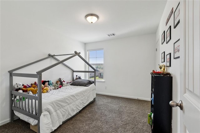 carpeted bedroom featuring visible vents and baseboards