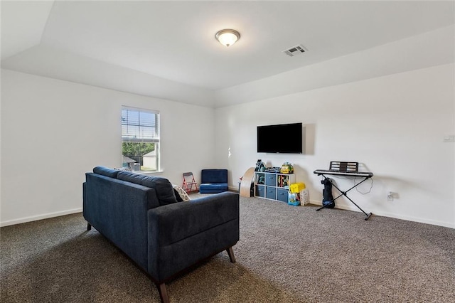 carpeted living area featuring visible vents and baseboards
