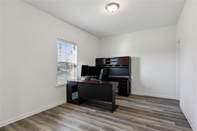 office space featuring wood finished floors and baseboards
