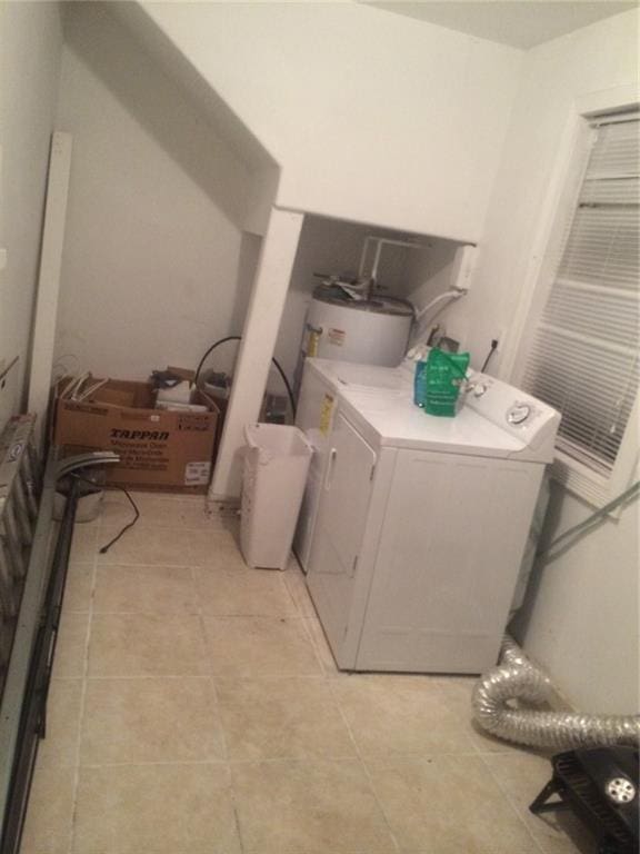 1569 Athis St, New Orleans, LA 70122 - laundry room featuring washer / clothes dryer, electric water heater, and light tile patterned floors