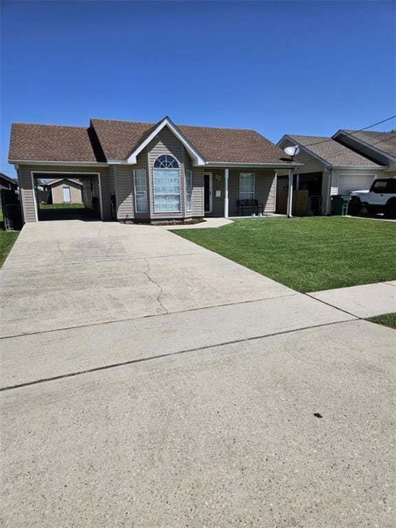 ranch-style home featuring concrete driveway and a front yard